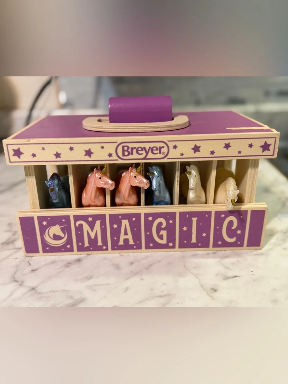 Breyer Unicorn Magic Wooden Stable Playset featuring a purple carrying case with